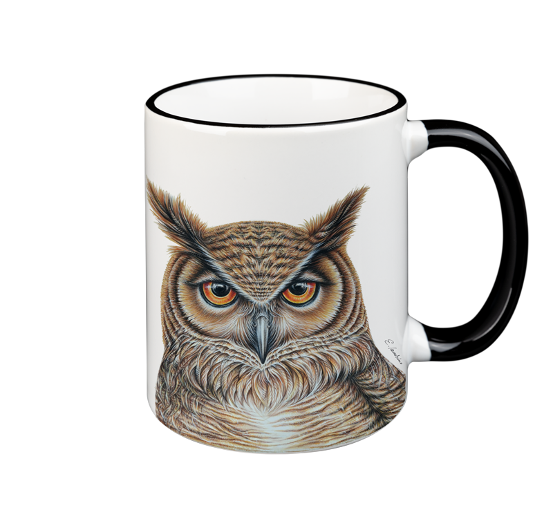 A white ceramic mug with a black rim and handle features a highly detailed, realistic illustration of an owl facing forward. The owl's feathers are colored in shades of brown and beige, and its intense eyes are vividly depicted. This Cuckoo's Nest Mug- Owl is both microwave safe and dishwasher safe.