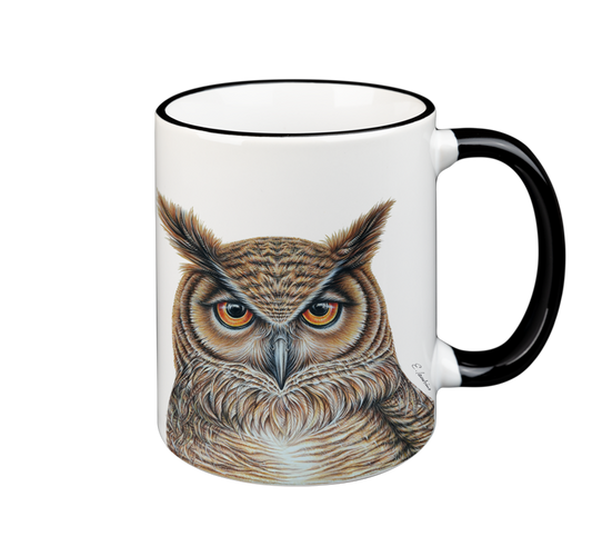 A white ceramic mug with a black rim and handle features a highly detailed, realistic illustration of an owl facing forward. The owl's feathers are colored in shades of brown and beige, and its intense eyes are vividly depicted. This Cuckoo's Nest Mug- Owl is both microwave safe and dishwasher safe.