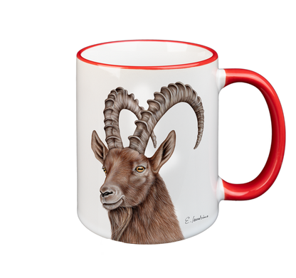 A white ceramic mug with a red rim and handle features a detailed illustration of a brown mountain goat with large, curved horns. The goat's head is facing forward, and there is a signature of the artist at the bottom right. This microwave and dishwasher safe Mug- Capricon by Cuckoo's Nest combines artistry with practicality.